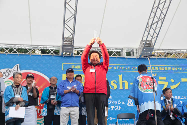 プライドフィッシュ料理コンテストのグランプリ賞を授与する高野農林水産大臣政務官