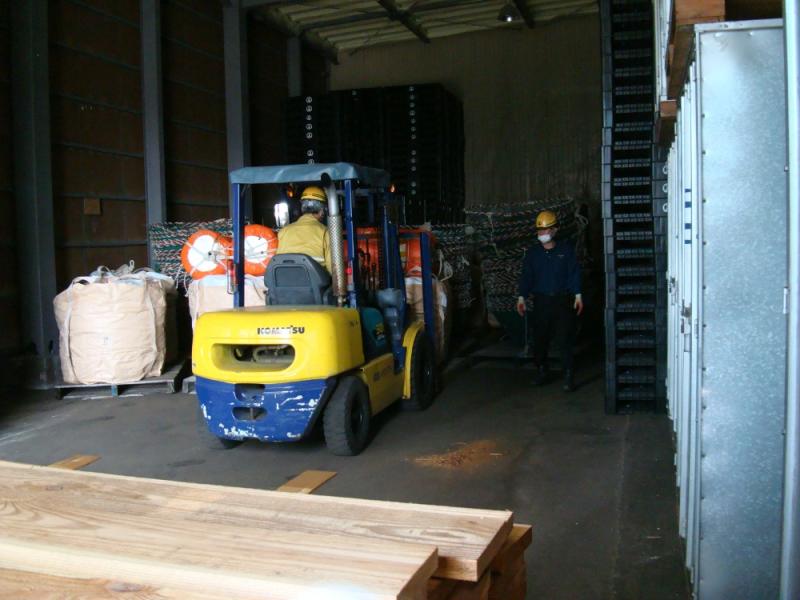 倉庫にてフォークリフトで漁具を運搬する様子